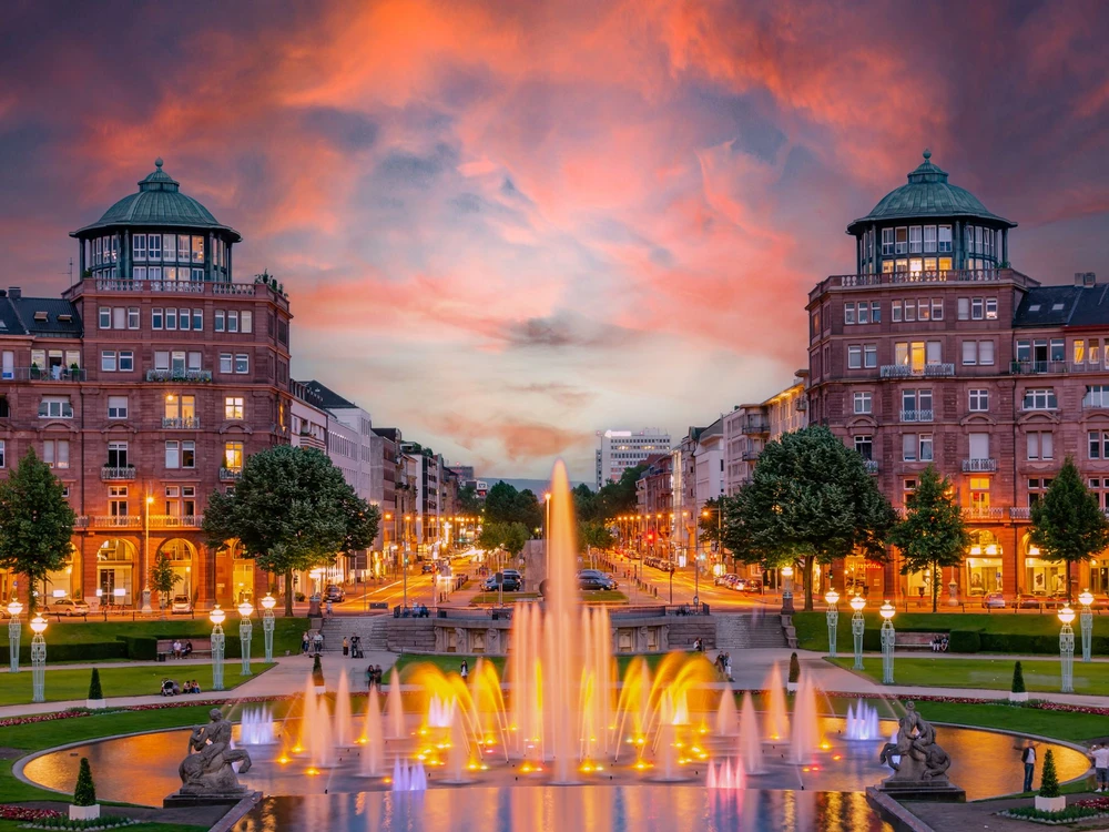 Mannheim, Germany. View on Friedrichsplatz at sunset with fountain creating splendid water and color effects. 2013-06-16.